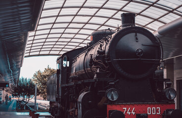 Old vintage black and red steam locomotive on railroads