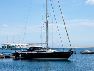 Fototapeta premium Side view boat in a pier, city mediterranean sea