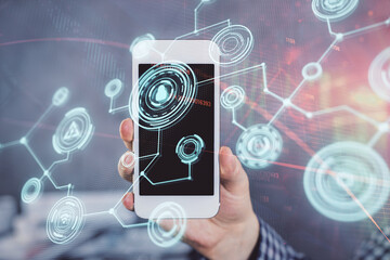 Double exposure of man's hands holding and using a phone and social network theme drawing.