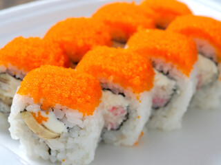 Food delivery. sushi rolls with salmon and caviar in disposable thermal dishes.