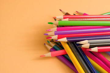 Fototapeta premium Close-Up Of colored pencil placed on yellow paper background with copy space for your image or text. High quality photo