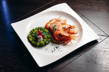 shrimps and avocado salad on white plate