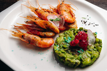 shrimps and avocado salad on white plate