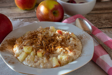 Porridge with sauteed apples, roasted almonds and cinnamon