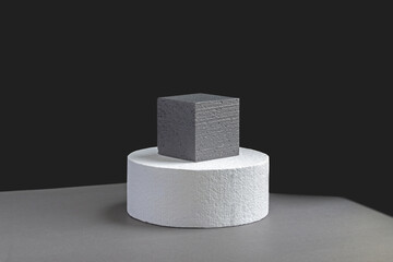 3d podium of geometric shapes: circle and square, standing on top of each other on black background. Concept of presentation of cosmetic products