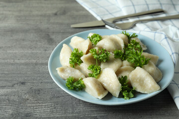 Concept of tasty food with vareniki or pierogi on gray textured table