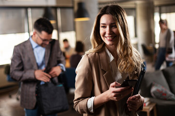 Businesswoman in office. Smiling businesswoman using the phone