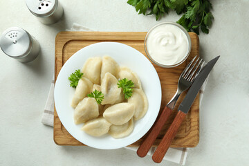 Concept of tasty food with vareniki or pierogi on white textured table