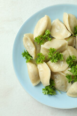 Concept of tasty food with vareniki or pierogi on white textured table
