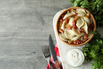 Concept of tasty food with vareniki or pierogi on gray textured table