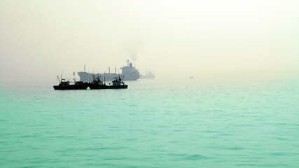 Fototapeta premium Amazing view of the Ships in the sea on a misty blue morning