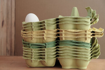 Stack of empty egg trays. Recycling of waste paper.