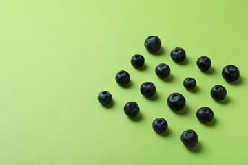 Fresh berry concept with blueberry on green background