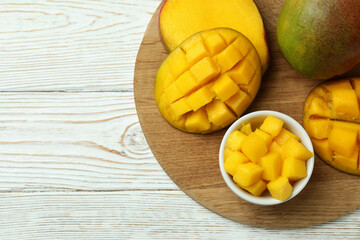 Tasty ripe mango fruit on wooden table