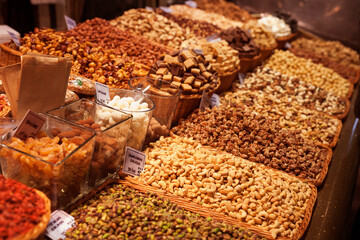 nuts and dried fruits on the counter in the market