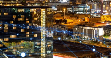 Glowing blue network of connections against view of cityscape at night