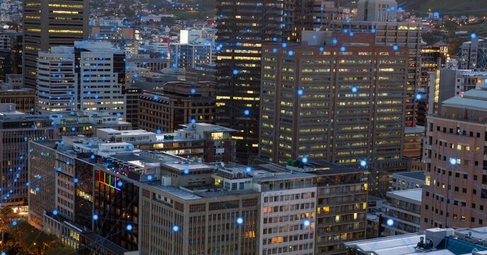 Glowing blue network of connections against view of cityscape at night