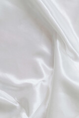 Beautifully draped white satin fabric. Minimalistic layout for you design. Copy space