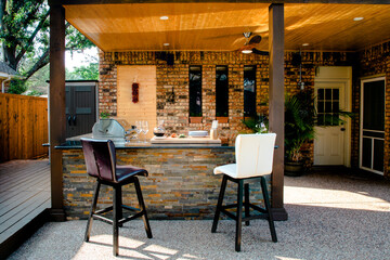New and modern outdoor kitchen on a sunny summer evening, dinner preparation - obrazy, fototapety, plakaty