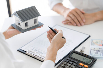 home loan insurance. .Real estate broker and client  sign contract insurance agreement document. Business meeting concept