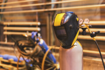 welding mask hanging on the oxygen tank