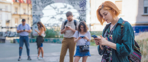 Group of friends using smartphones together. Young people addiction to new technology trends....