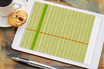 business concept - data spreadsheet on a digital tablet with a cup of coffee - obrazy, fototapety, plakaty