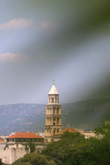 Saint Domnius bell tower, historic landmark in Split, Croatia, seen through the leaves. Selective focus.