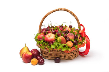 Fototapeta na wymiar Basket with fresh fruits and berries on a white background