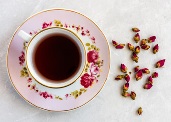 Fototapeta na wymiar cup of tea and red rose