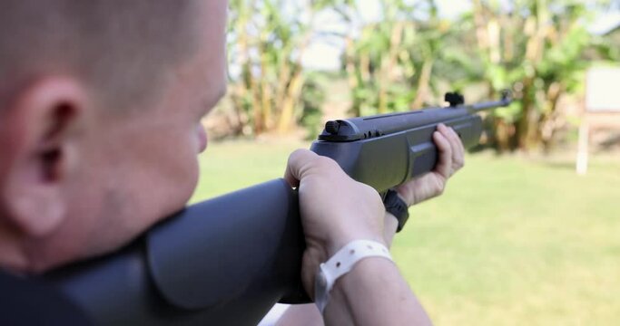 Man shooting gun at target and getting recoil 4k movie