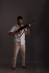 Man in white shirt with submachine gun