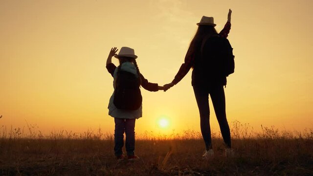 Silhouette of children in park.Happy children are walking at sunset.Family holding hands in park dreaming.concept of happy family childhood dream. Silhouette of children with hands up at dream sunset.
