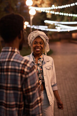 African young couple walking together in the evening in the park