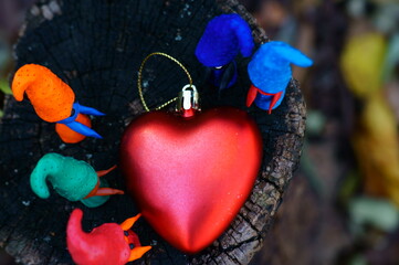 Figures of colorful gnomes with a toy heart.