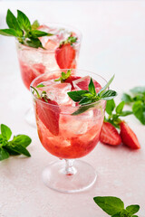 Strawberry cocktail drink with ice and oregano.