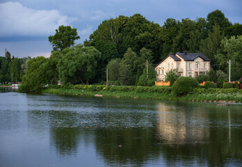Fototapeta na wymiar Beautiful mansion on a calm river in the small town