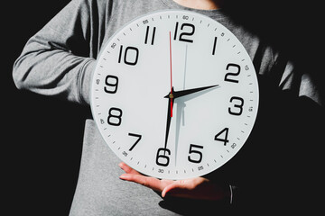 person holding clock