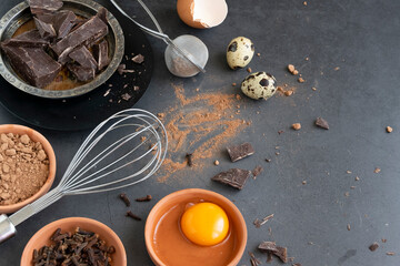 Mix of baking dessert ingredients on dark background, culinary flat lay