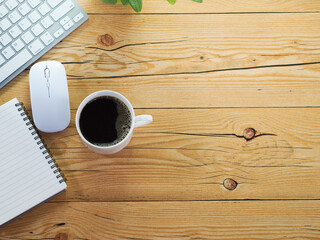 Top view office table desk workspace with black coffee and computer notebook,notepad on wooden background.