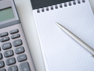 Template with caculator pen notepad on white table top view background.