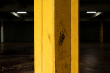 Hand mark on a yellow painted steel beam
