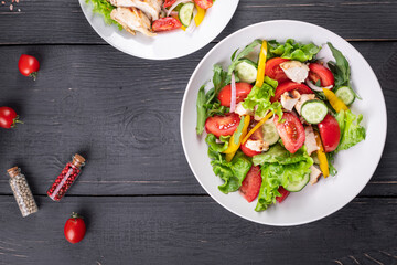 vegetable salad and chicken meat vegetables fresh tomato, cucumber, pepper organic dish on the table healthy food meal snack copy space food background rustic. top view