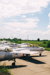 Close-up of a military fighter pilot's cockpit. A crack is visible on the glass, which has turned yellow with age. Decommissioned military equipment. Airplane pilot seat