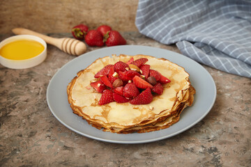 Pancakes, thin pancakes with fresh strawberries. On an empty background. Copy space.