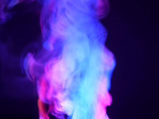 Abstract color series. Composition of colorful smoke in motion. Fusion of purple and blue mist isolated on a dark background to inspire creativity.