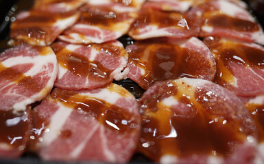 selective focus of slice pork meat with sauce