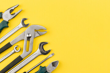 Work tools on bright yellow background with copy space. Top view, flat lay