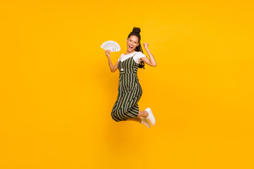 Full length photo of carefree lucky dark skin lady back wear striped clothes fist holding money fan...