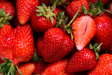 Close up, texture and background of red ripe, freshly harvested strawberries in summer